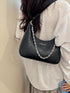 Chain-Detail Shoulder Bag: Black chain-detail bag worn, side view