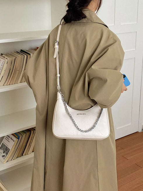 Chain-Detail Shoulder Bag: White chain-detail bag worn, side view