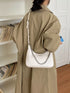 Chain-Detail Shoulder Bag: White chain-detail bag worn, side view