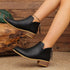 V-Cut Faux Suede Ankle Boots: Black ankle boots worn with one foot raised