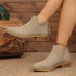 V-Cut Faux Suede Ankle Boots: Light beige ankle boots worn with one foot raised
