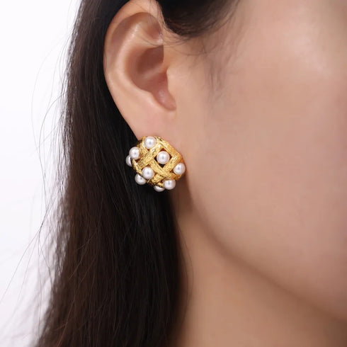 Shell Pearl Stud Earrings: Gold-tone white-bead stud earring worn, close-up