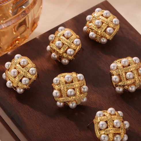 Shell Pearl Stud Earrings: Gold-tone white-bead stud earrings on brown fabric