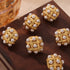 Shell Pearl Stud Earrings: Gold-tone white-bead stud earrings on brown fabric
