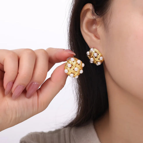 Shell Pearl Stud Earrings: Matching white-bead stud earring held beside worn earring