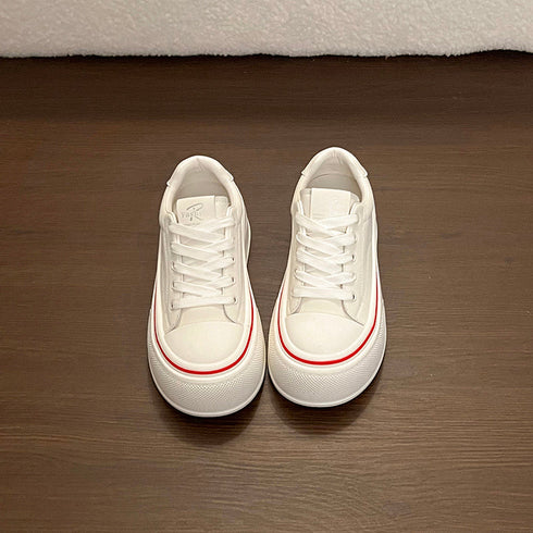 Top view of white lace-up platform sneakers with closed round toes