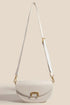 Beige crescent purse shown with its full crossbody strap