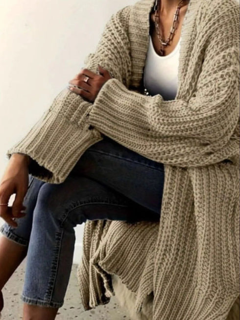 Khaki chunky open-front cardigan worn with jeans, seated view