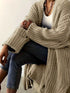 Khaki chunky open-front cardigan worn with jeans, seated view