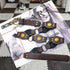 Brown medallion belt arranged on a magazine, showing round metal accents and pin buckle