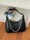 Chain-Detail Shoulder Bag: Black shoulder bag with silver-tone chain displayed on wooden table