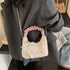 Cream bow-detail mini purse with pink handle, closer worn view