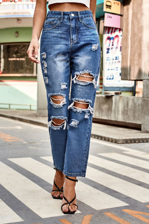 Distressed High-Waisted Straight-Leg Jeans: Blue distressed jeans modeled with hand at waist