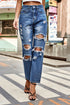 Distressed High-Waisted Straight-Leg Jeans: Blue distressed jeans modeled with hand at waist