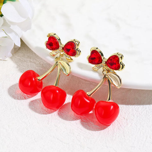 Pair of red cherry earrings with gold-tone stems and bow details