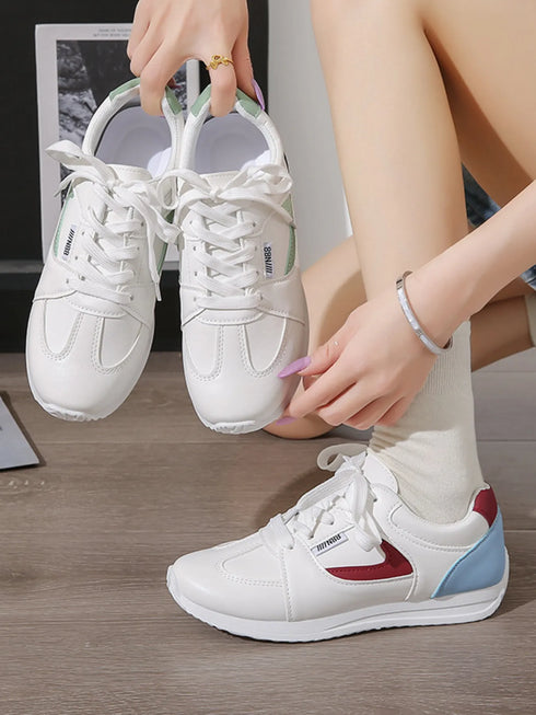 White lace-up sneakers showing red and green contrast accent options