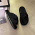 Black fleece bow slide slippers with dark rubber soles