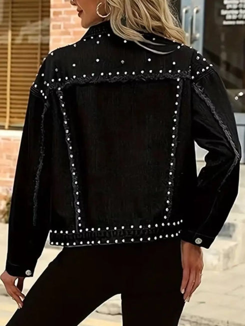 Back view of black denim jacket with silver-tone studs along the yoke and hem