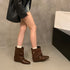 Brown buckle-strap boots worn with shorts, rear angled view