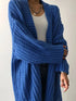 Close view of Blue cardigan knit texture and open front
