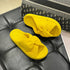 Yellow bow slide slippers with ribbed uppers and dark soles