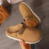 Brown clogs viewed from above with one shoe held in a hand