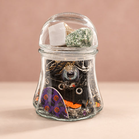 Side view of Halloween mystery jewelry jar showing assorted jewelry and seasonal designs.
