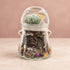 Clear jar filled with a mixed Halloween jewelry assortment in black, orange, and purple.