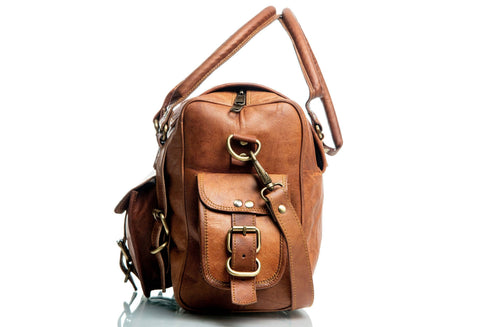 Side view of Walker Tanned leather bag showing the buckle pocket and strap attachment