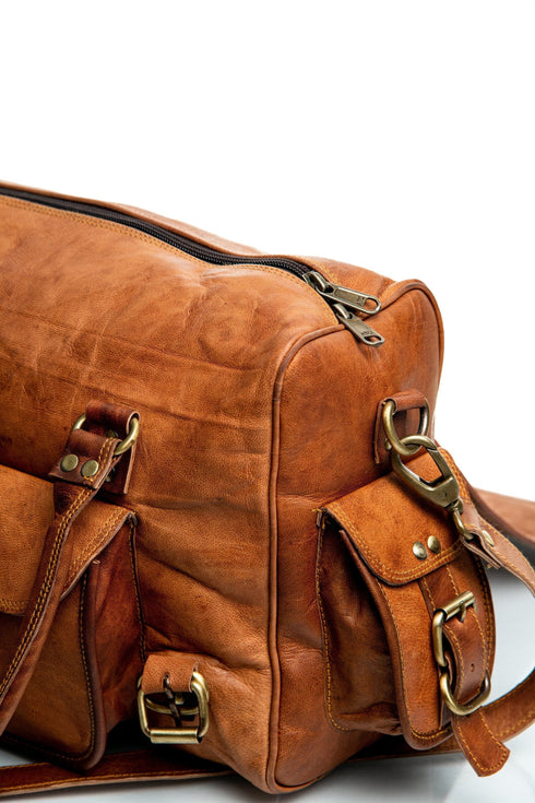 Walker Tanned bag side detail showing the top zipper, buckle pocket and detachable strap clip