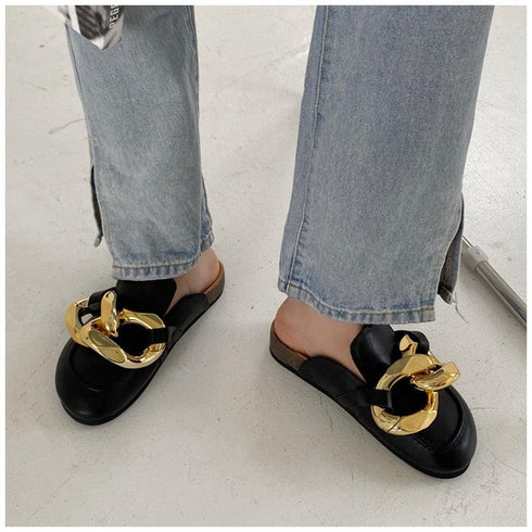Black chain-detail mules worn with light blue jeans