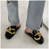 Black chain-detail mules worn with light blue jeans