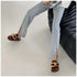 Brown chain mule flats styled with a white top and light blue jeans