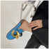 Blue chain mule held by hand showing the microfiber upper and open heel