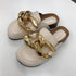 Beige closed-toe chain mule flats with tan footbeds
