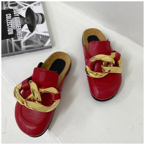 Red chain mule flats displayed together on white