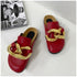 Red chain mule flats displayed together on white