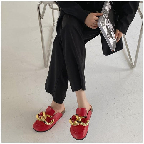Red chain mule flats worn with wide cropped black trousers