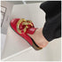 Close-up of red STEVVEX mules and oversized gold-tone chain trim