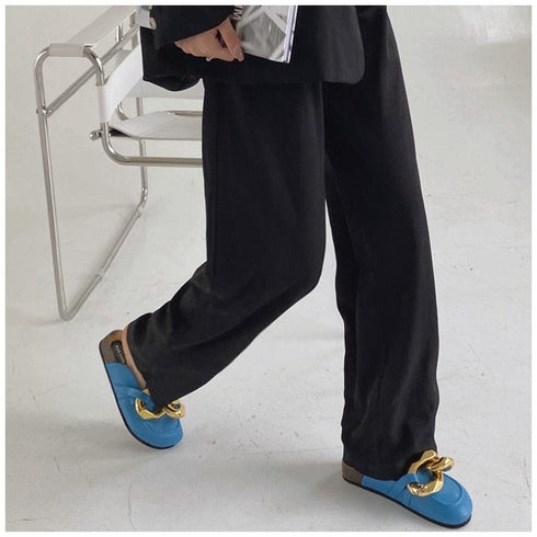 Blue chain mules worn with black wide-leg pants