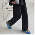 Blue chain mules worn with black wide-leg pants
