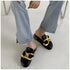 Black chain mules styled with light blue straight-leg jeans