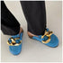 Blue chain-detail mules shown while worn, viewed from above