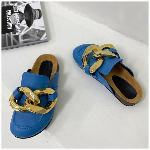 Blue STEVVEX mule flats showing gold-tone chain decoration and open heels