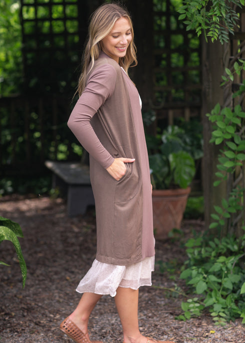 Side view of muted mauve-toned cardigan showing a deep pocket