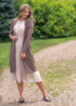Kylin cardigan layered over a pink dress on an outdoor path