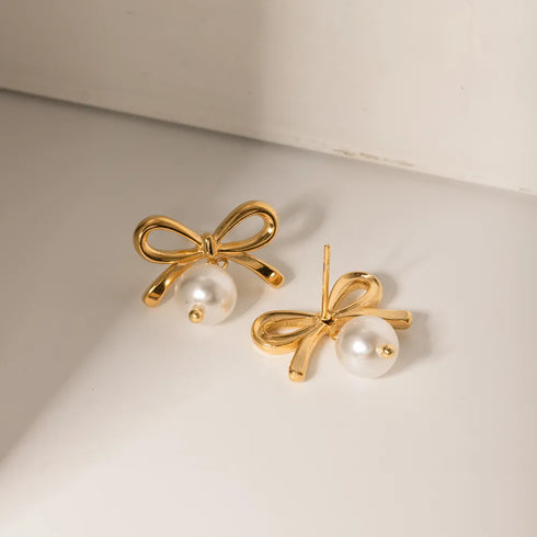 Gold-Tone Bow Earrings with Synthetic Pearls: Bow earrings showing front and back on cream surface