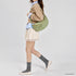 Moss Genova crossbody bag shown on a model with tailored clothing