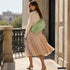 Moss Genova bag styled across the body on a model outdoors