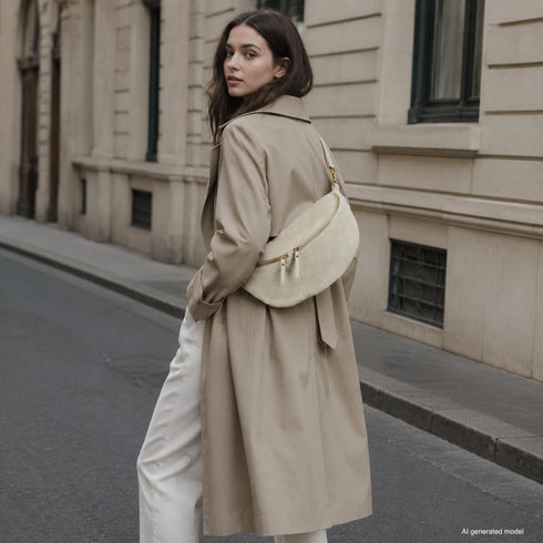 Beige Genova bag styled across the body on a model outdoors